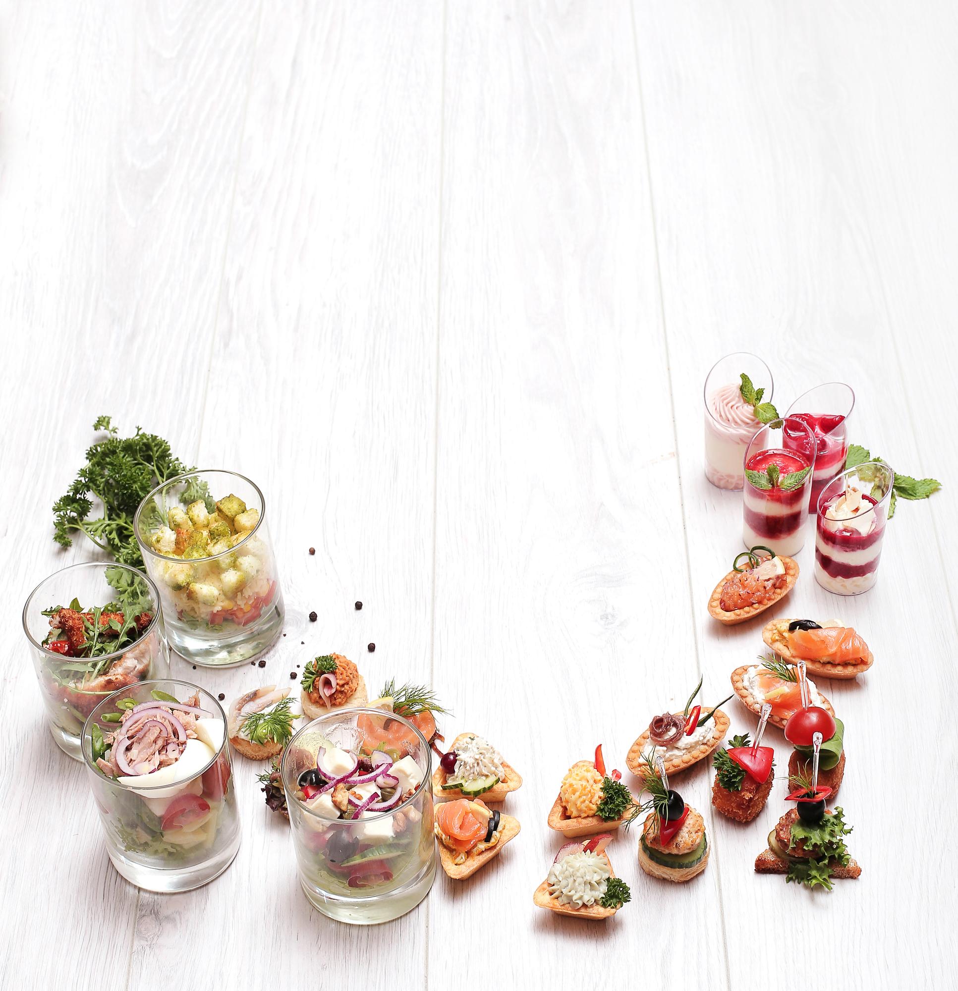 Assorted plated appetizers on a wooden table